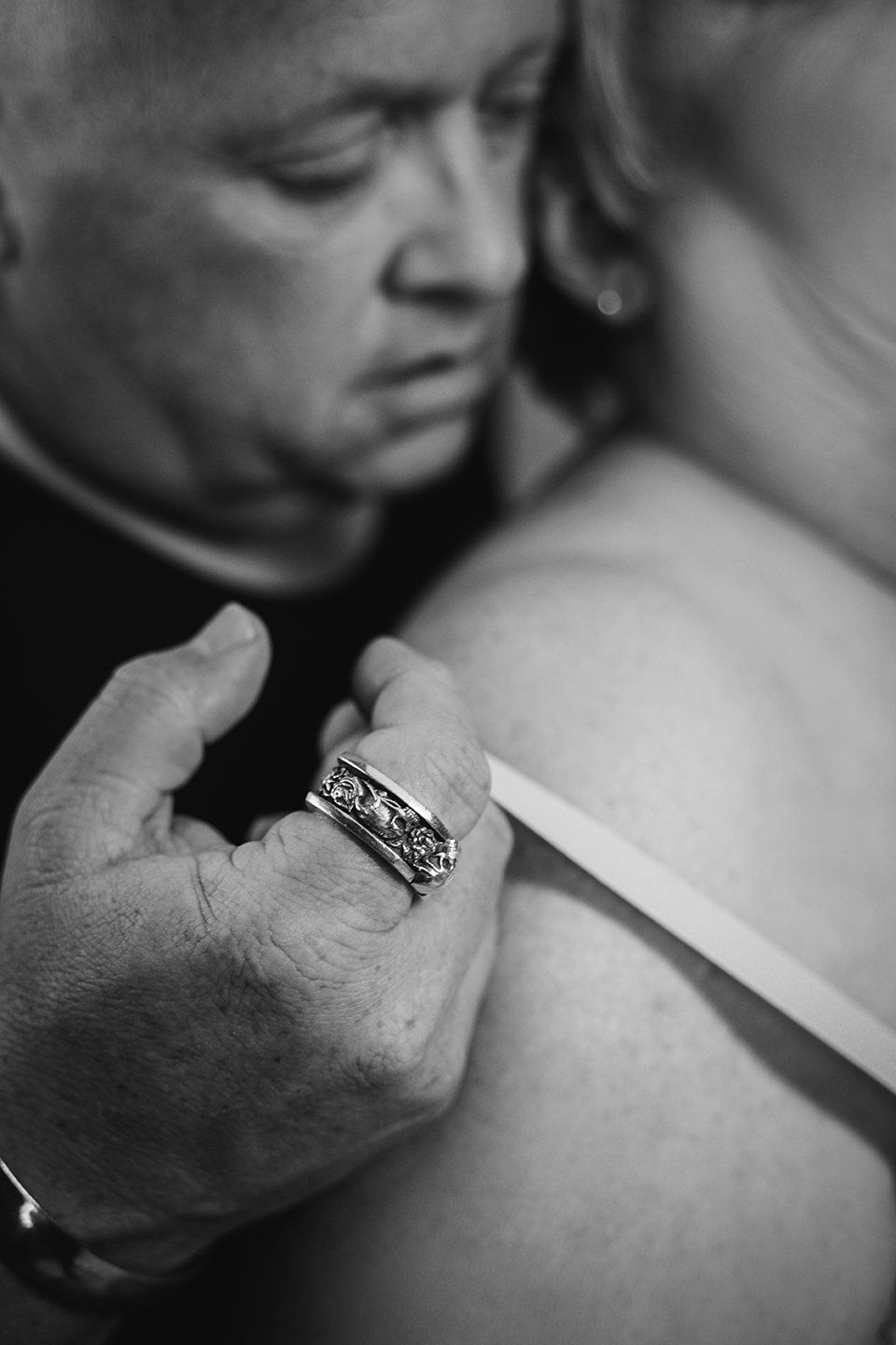 man pulling off woman't bra strap, closeup shot