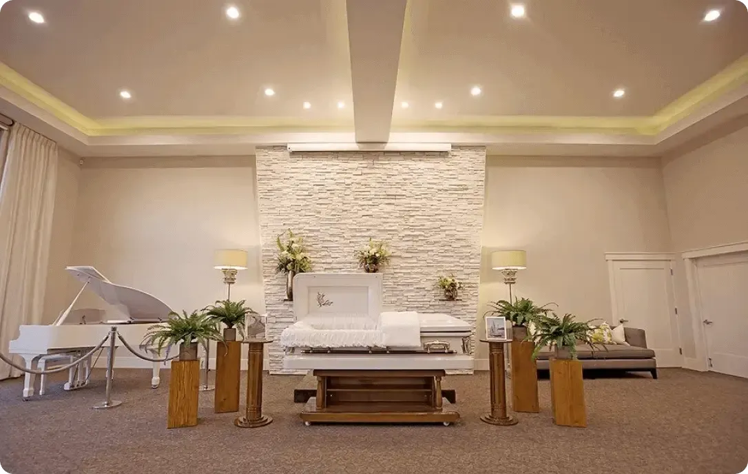 Elegant wedding chapel with white floral altar, grand piano, and soft beige lighting