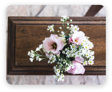 Pink and white flowers on a rustic wooden box