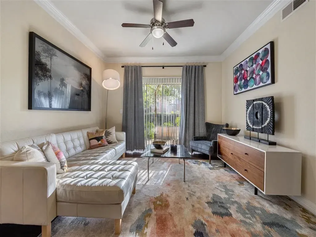 Spacious living room with sectional sofa, coffee table, and modern entertainment console.
