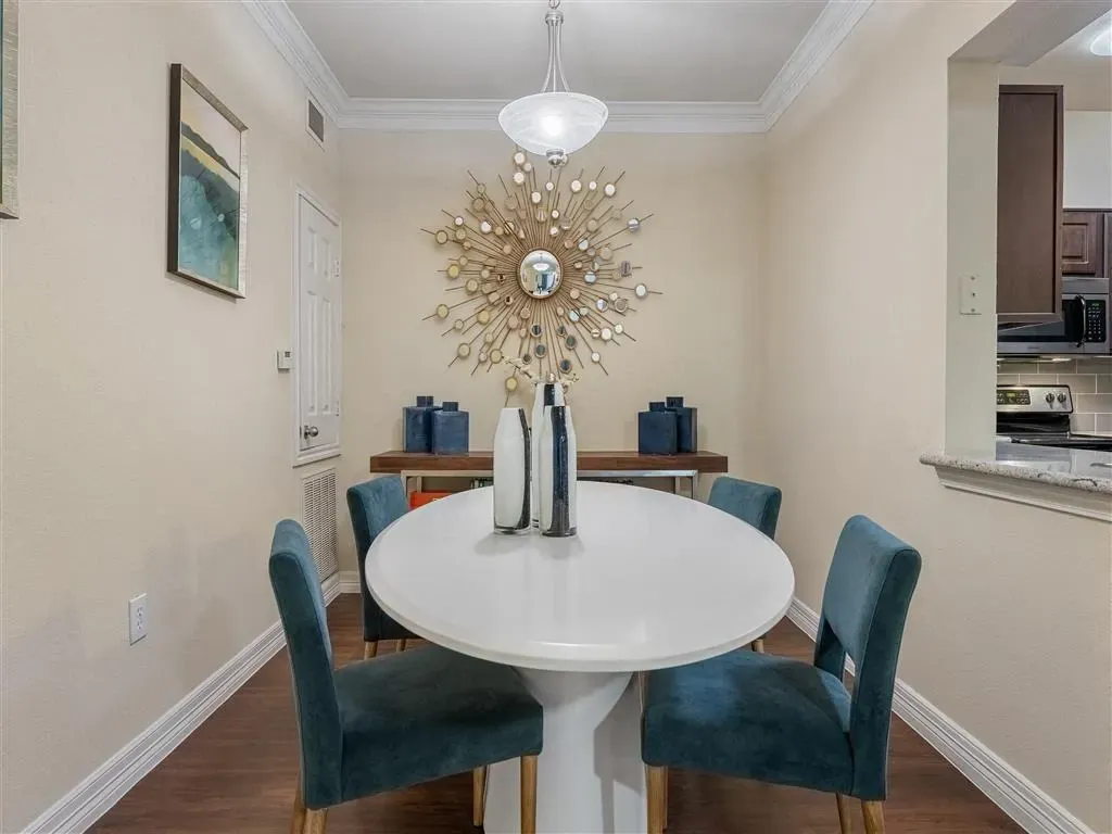 Dining area with a white table and blue chairs.