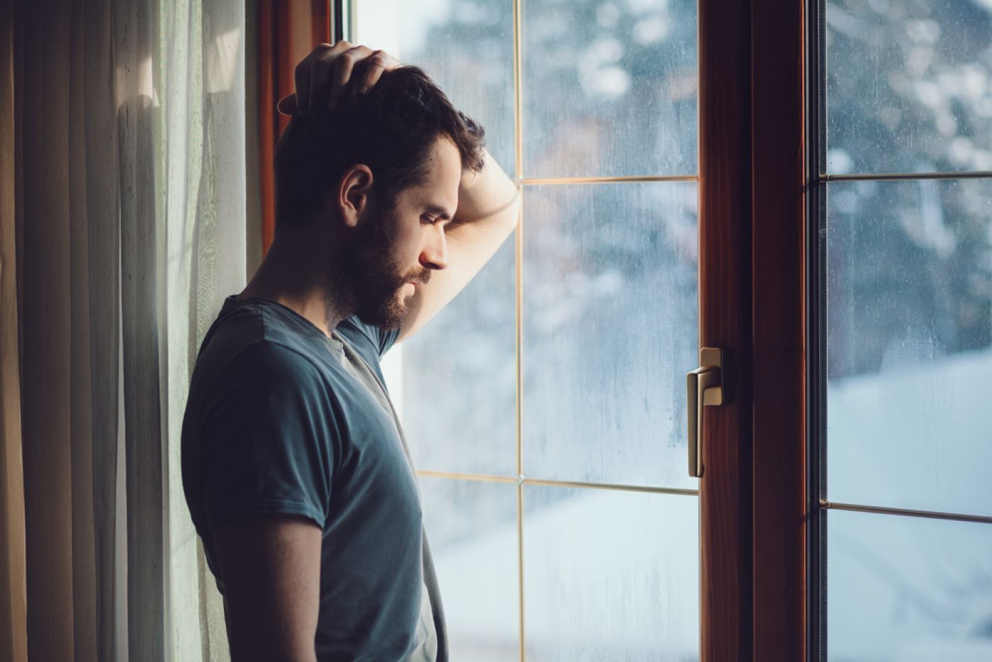 A Man Is Standing in Front of A Window — Moving Beyond OK In Springwood, QLD
