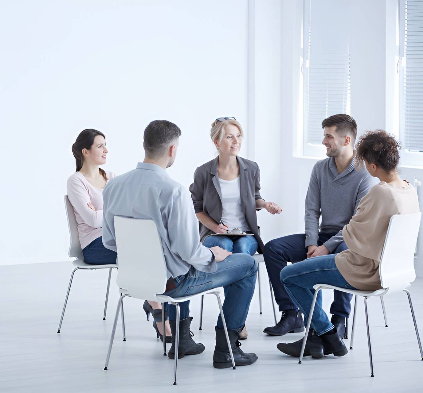 A Group of People Are Sitting in A Circle Talking to Each Other — Moving Beyond OK In Mount Warren Park, QLD