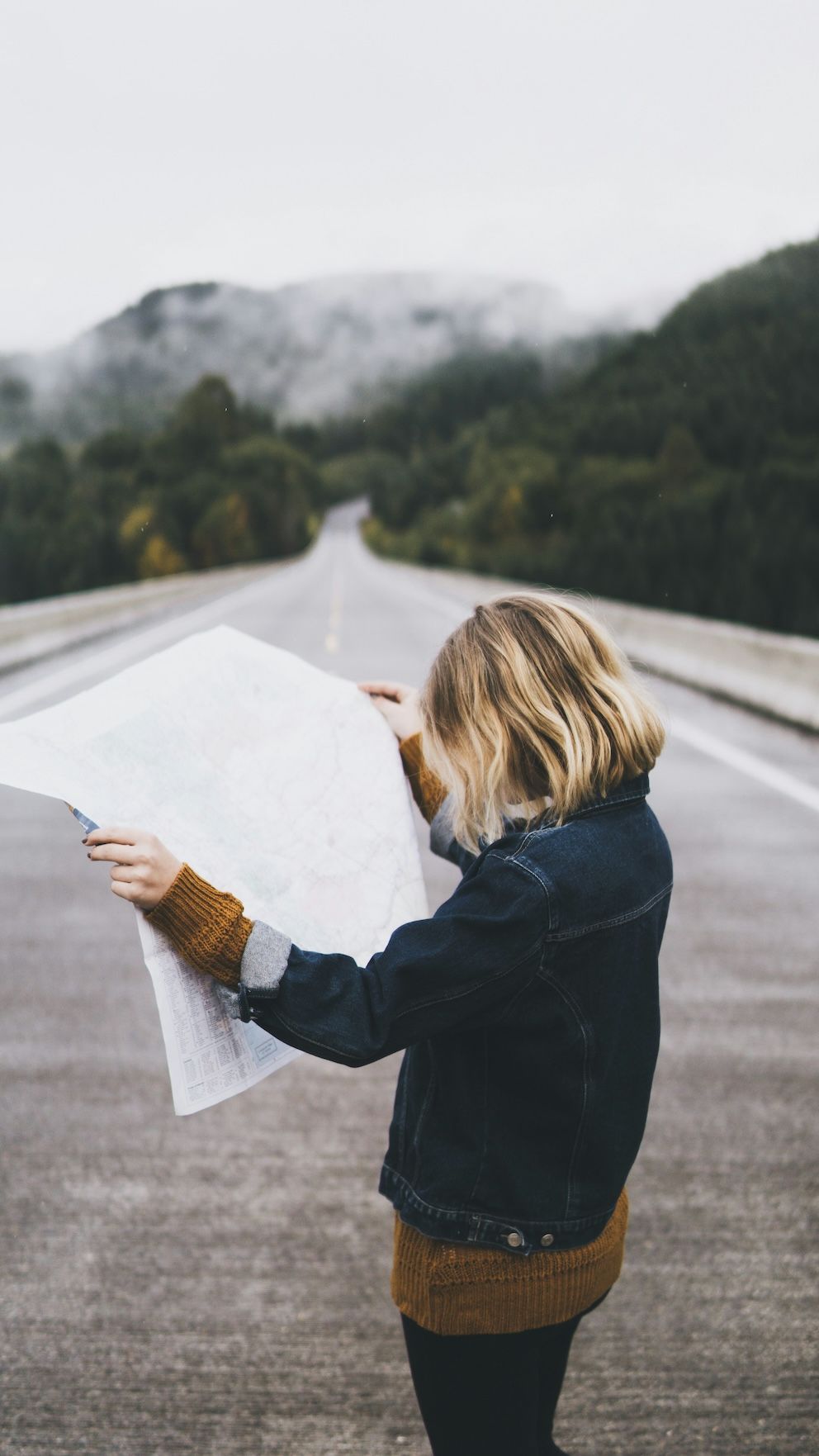 A Woman Is Standing on A Bridge Looking at A Map — Moving Beyond OK In Mount Warren Park, QLD