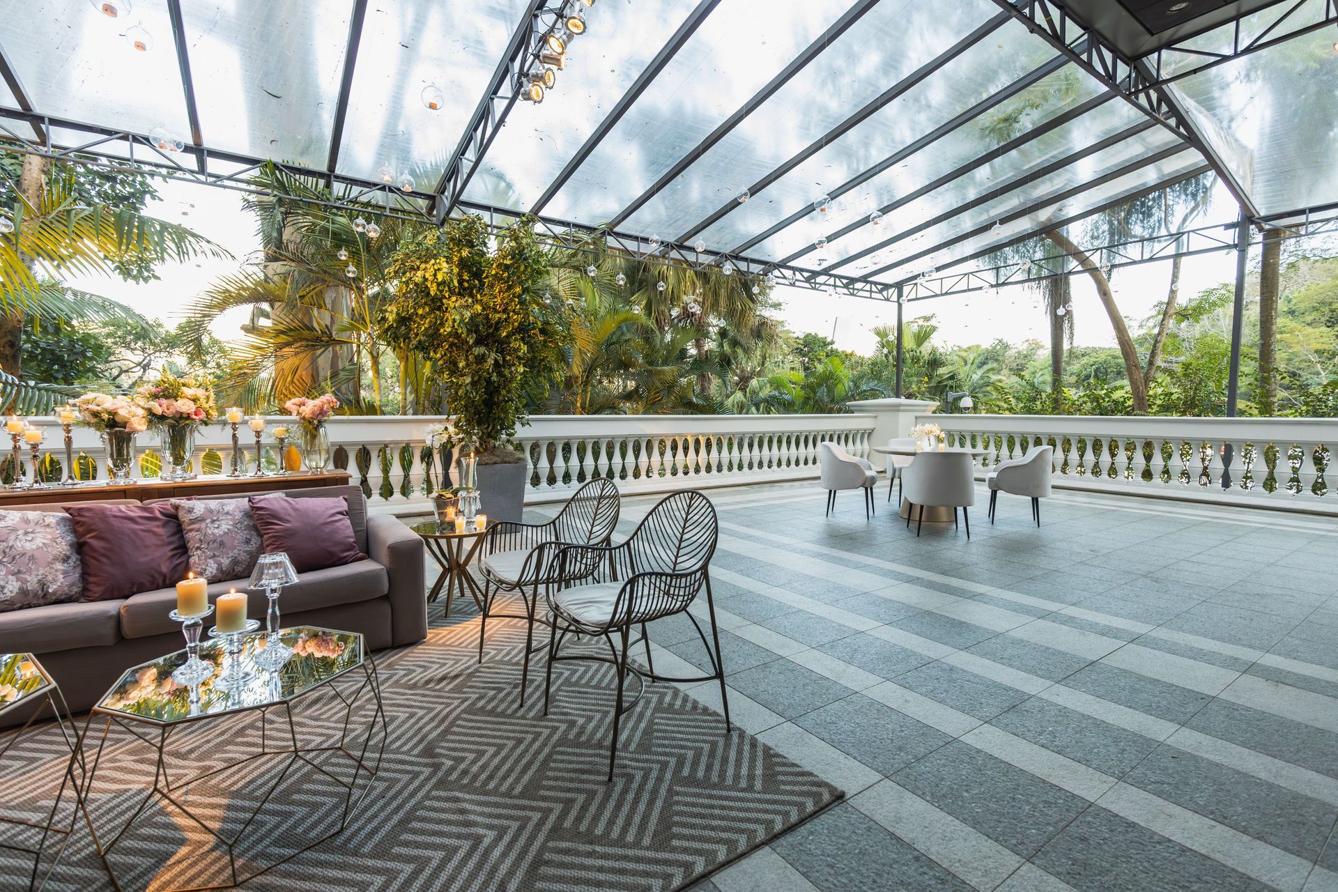 Decked terrace with railings under a glass pergola