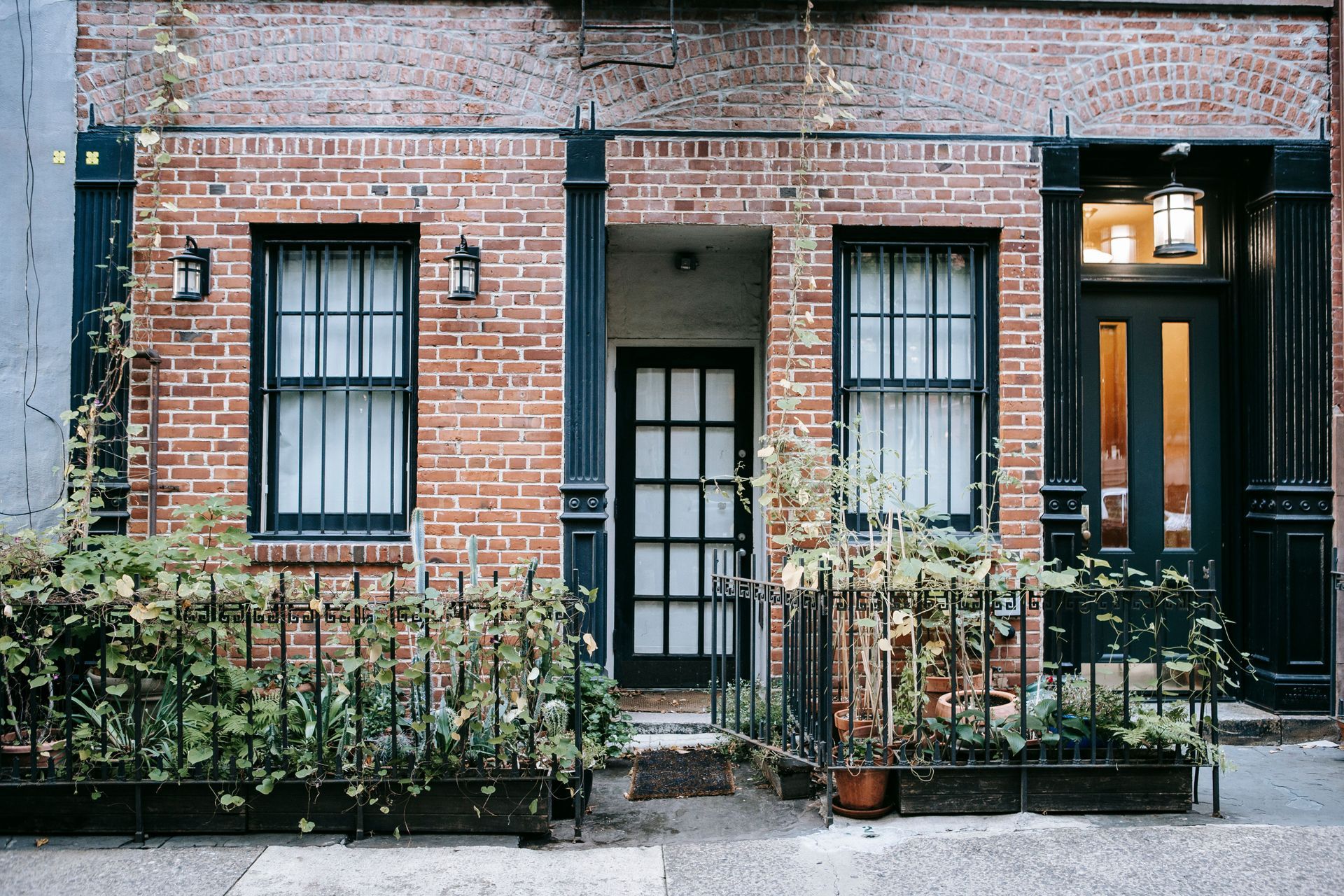Brick terraced house with a low front garden wall