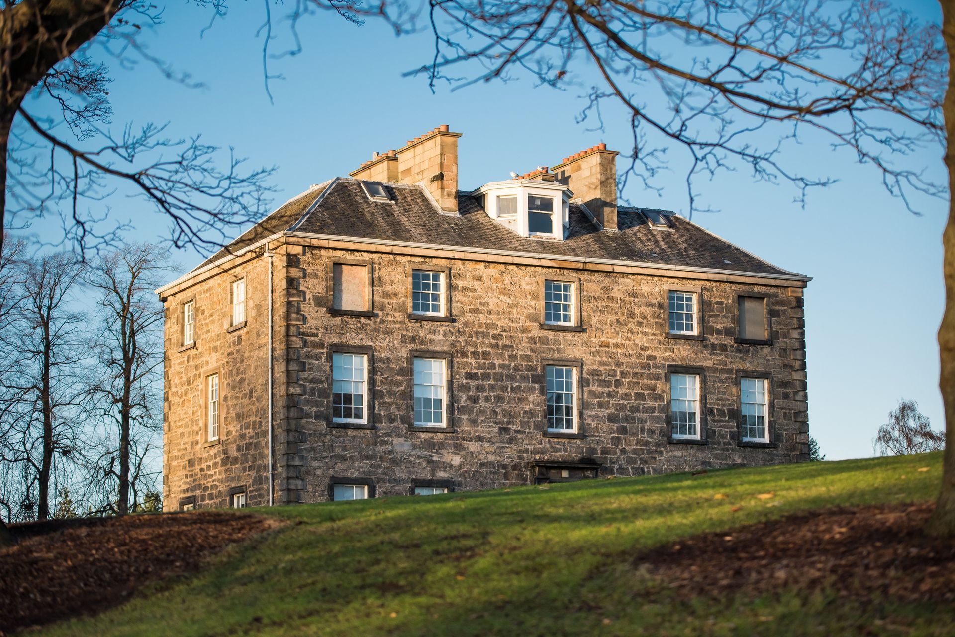 Traditional sandstone house with stone walls and sash windows
