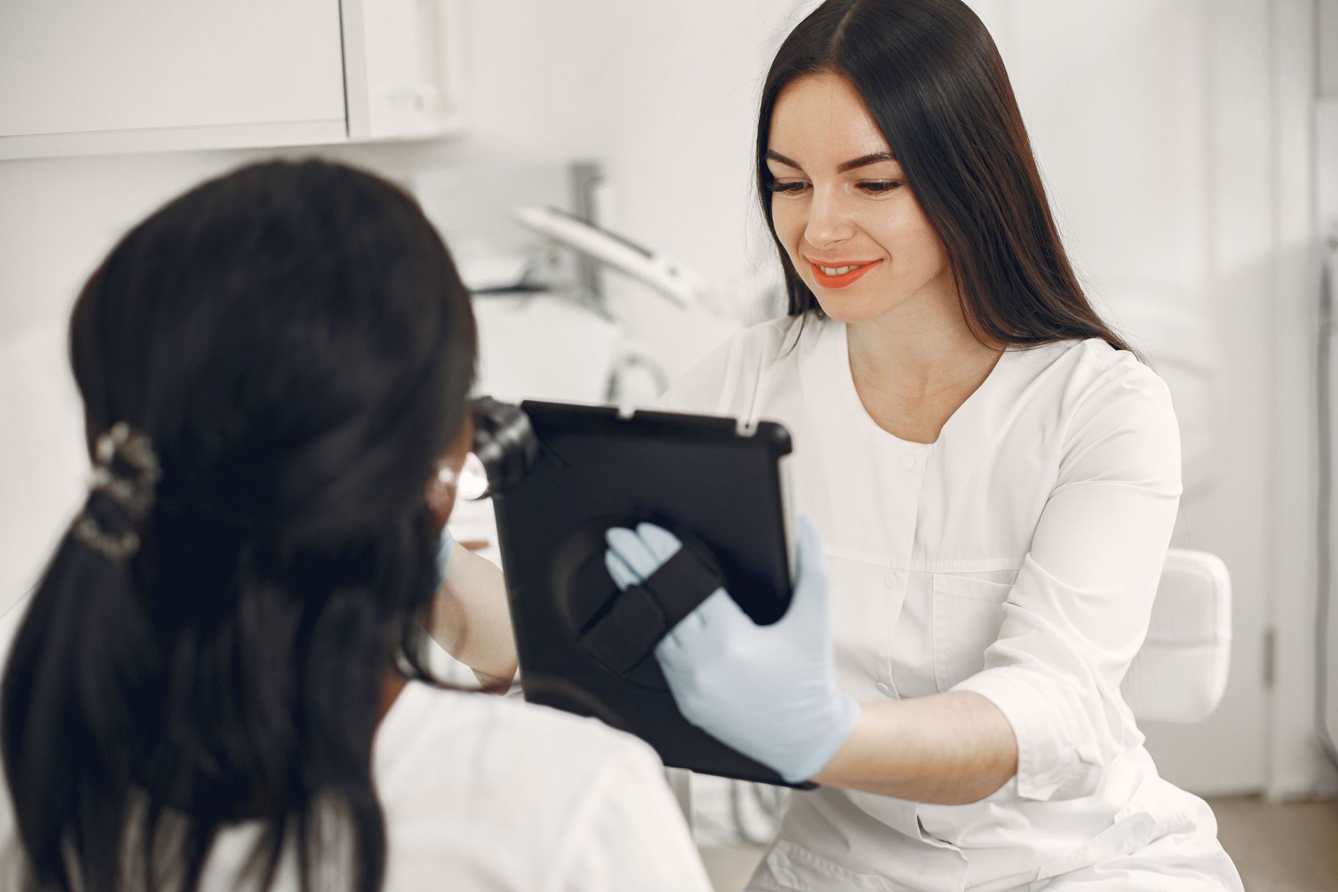 Practitioner examining a client's skin before treatment