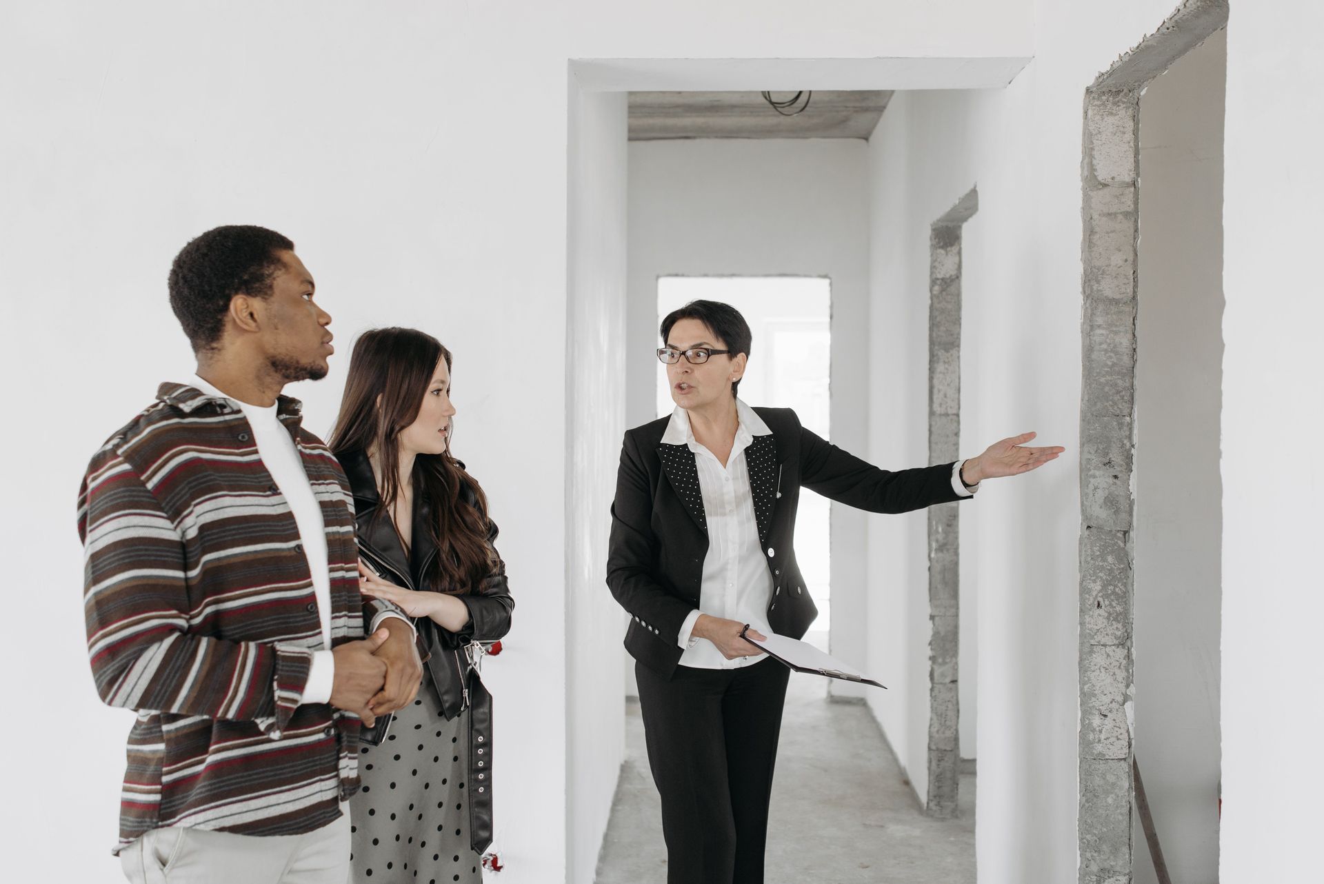 Agent showing a couple around an empty property