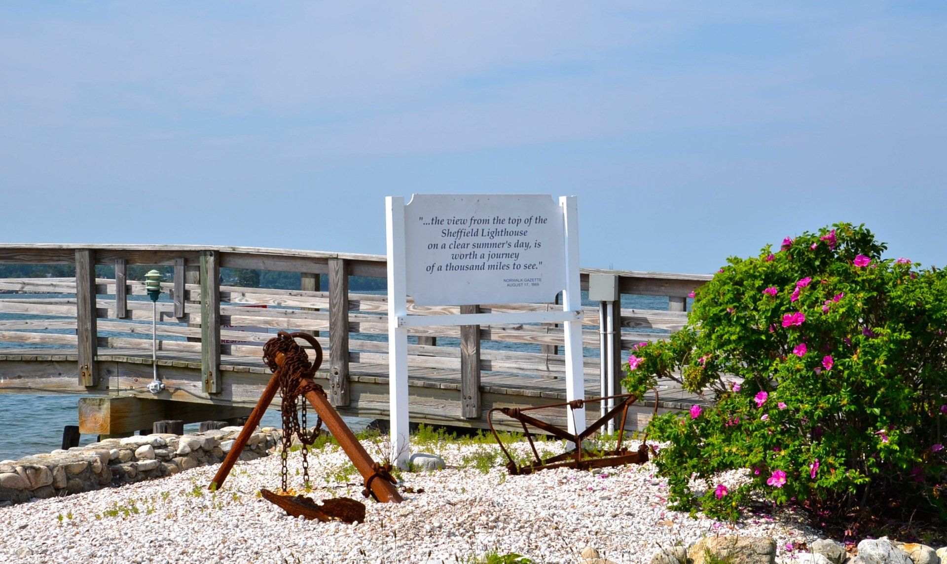 A sign that says ' anchors ' on it in front of a wooden fence