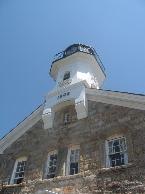 A stone building with a clock tower on top of it