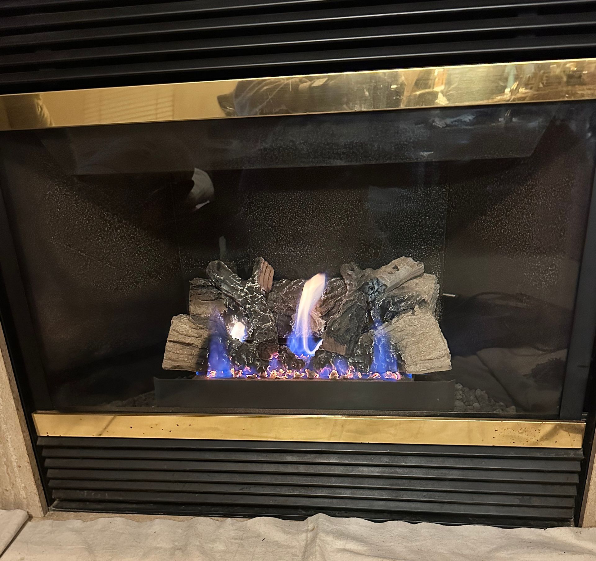 A fireplace with blue flames coming out of it.