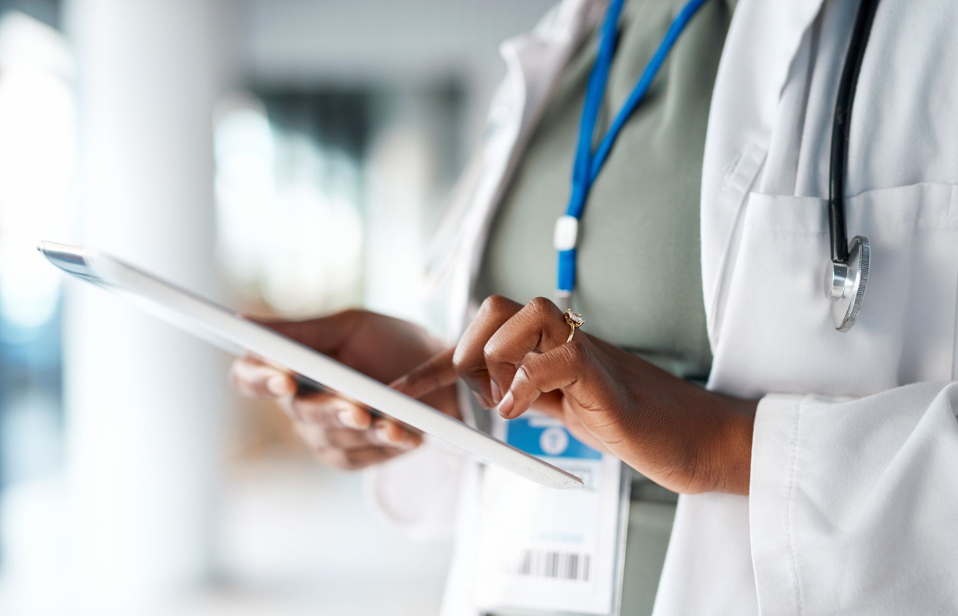 A doctor is using a tablet computer in a hospital.