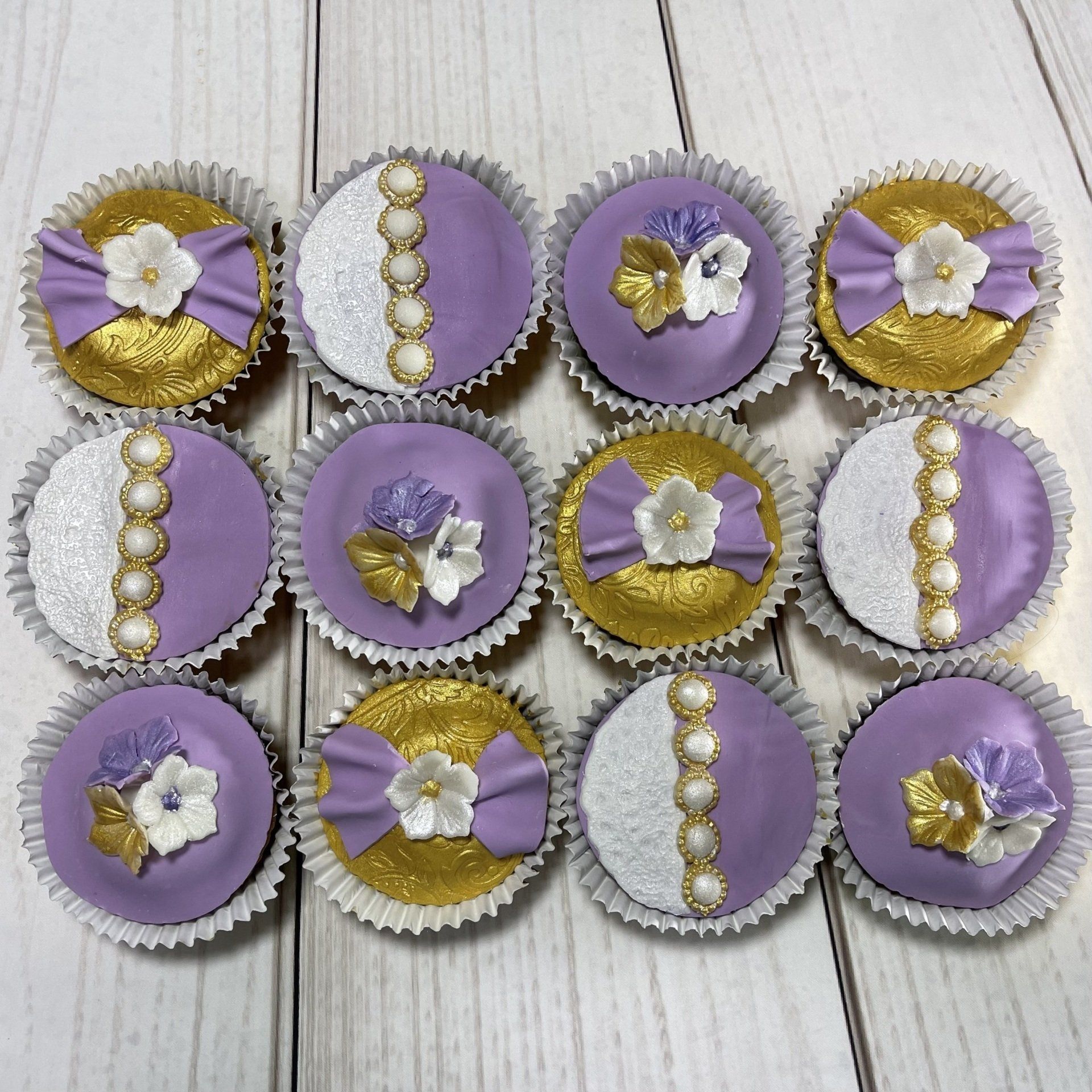 Elegant Mauve, Pearl and gold cupcakes with fondant lace and pearls.