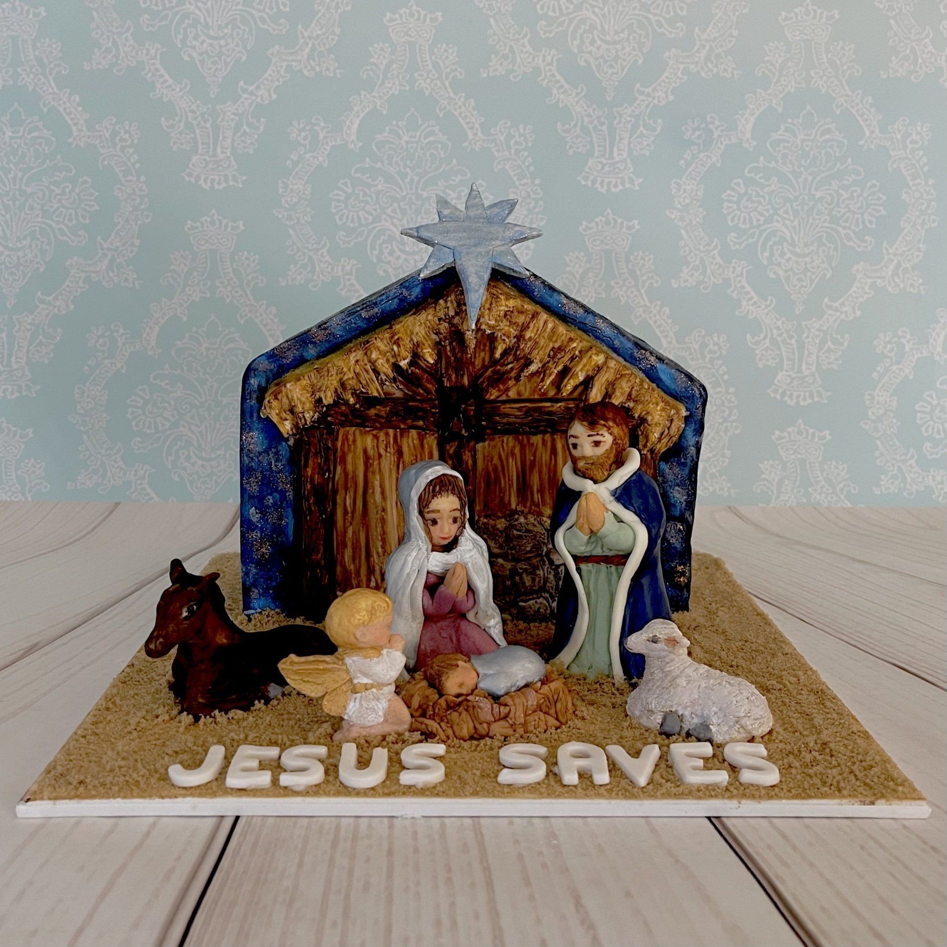Christmas Cake, nativity stable with a hand sculpted Donkey, Sheep, Mary, Joseph and Baby Jesus,