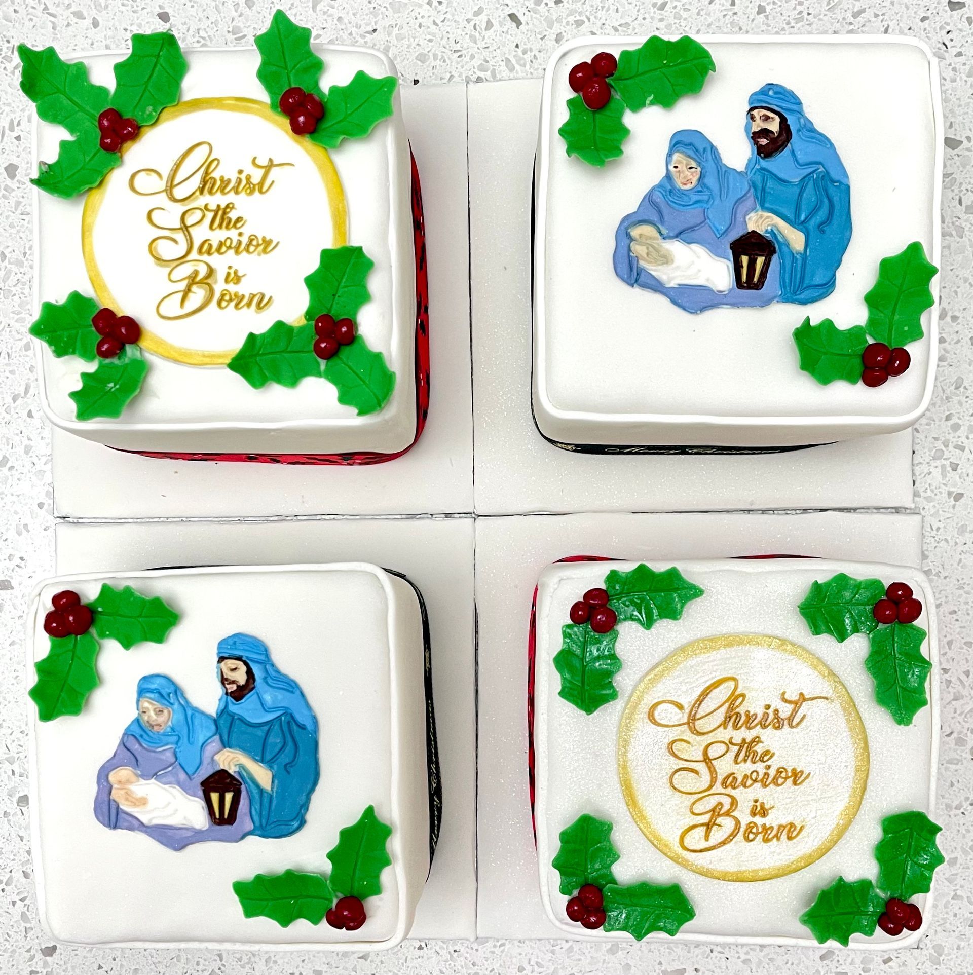 Set 4 Christmas cakes decorated with nativity holly and Christ the Saviour is born.