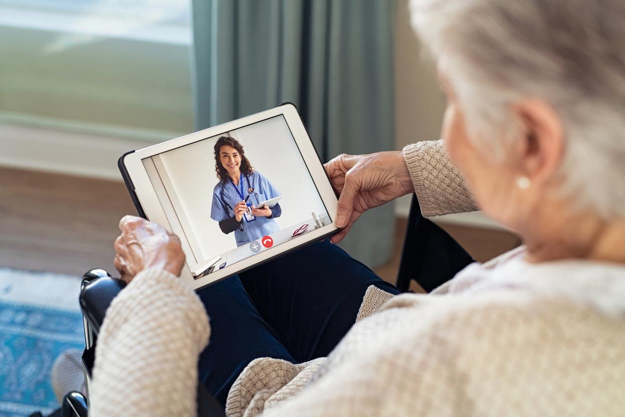 Person using a tablet during a video call on a couch