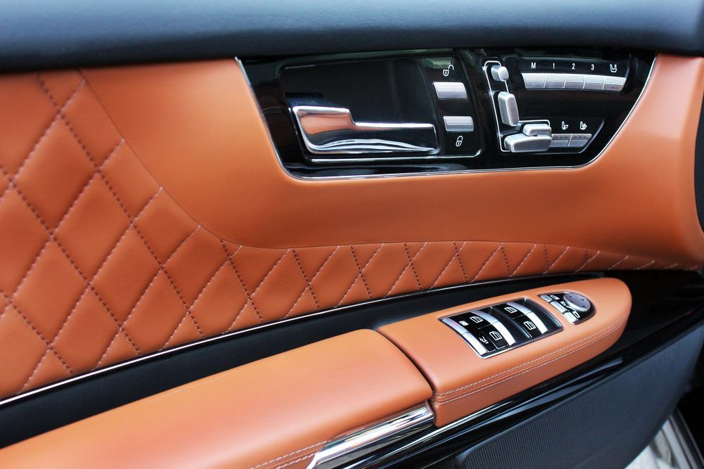A Close Up Of A Car Door With Brown Leather And Chrome Trim — All Clean Auto Detailing In Newcastle, NSW