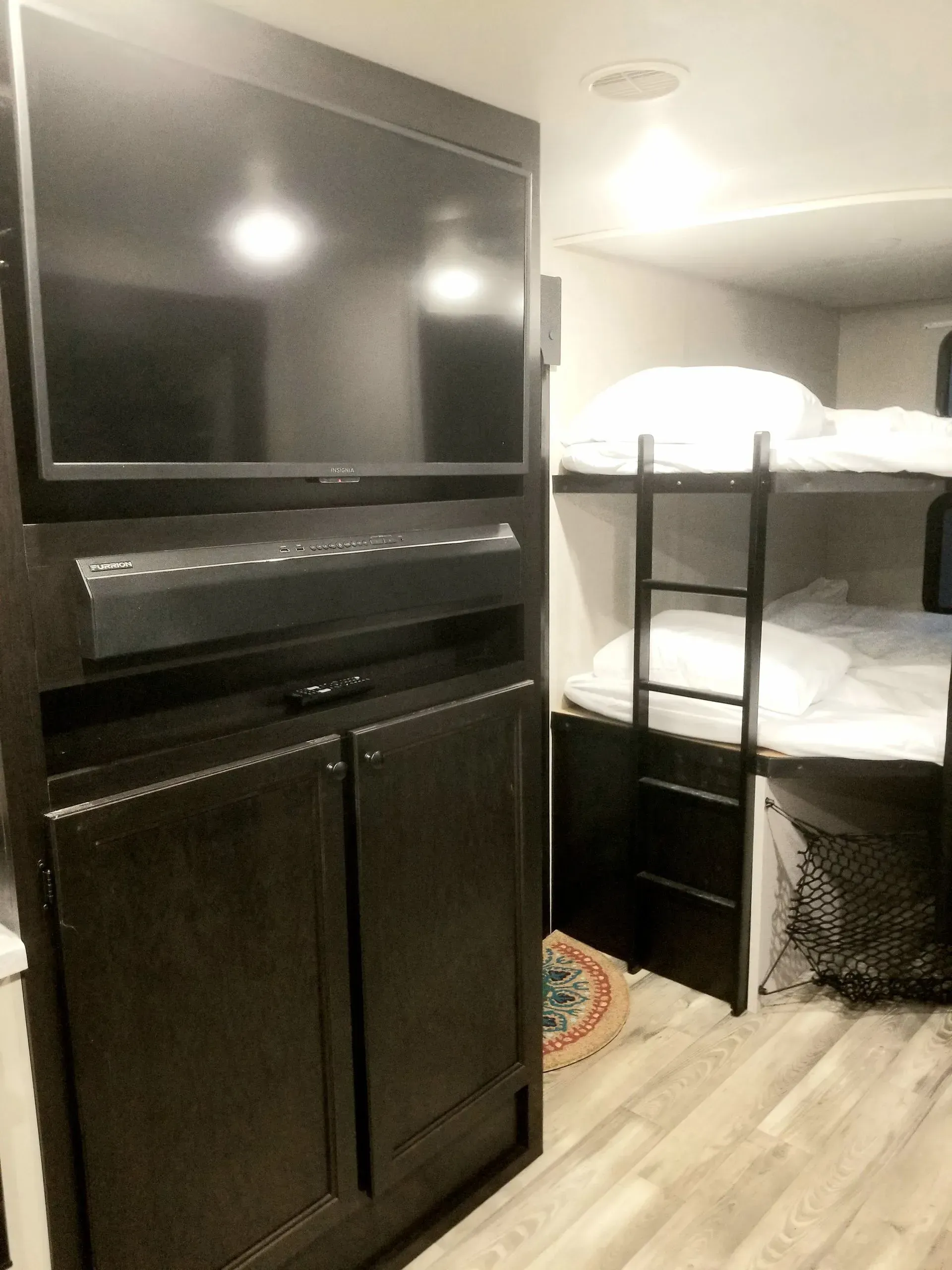 A bedroom with bunk beds and a flat screen tv