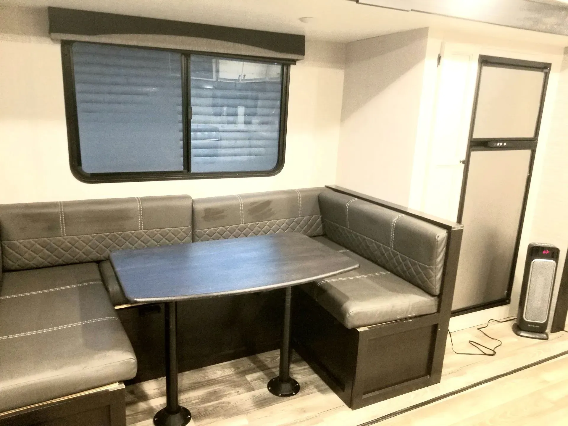 A rv with a table and benches in the living room.