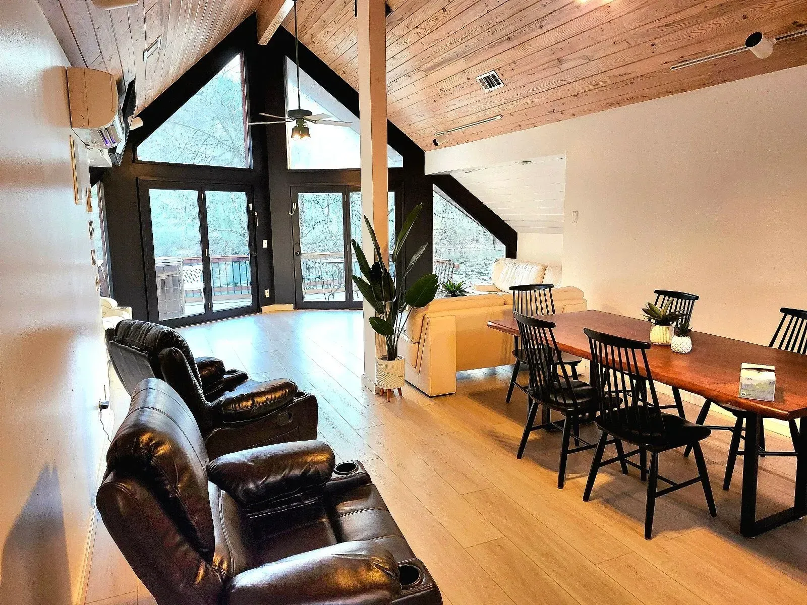 A living room with a couch , chairs , and a table.