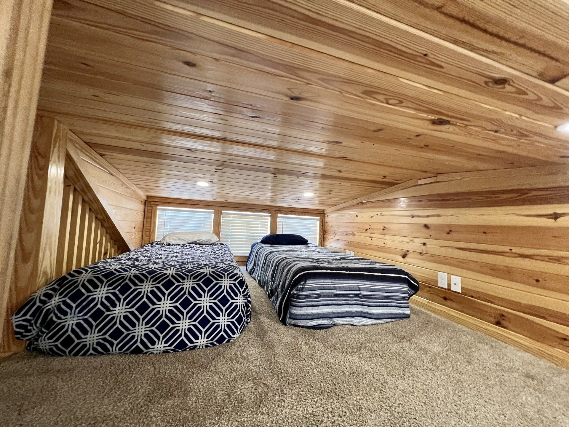 two twin beds in loft of zoo cougar cabin at copper johns