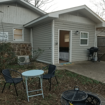 A small house with a table and chairs in front of it