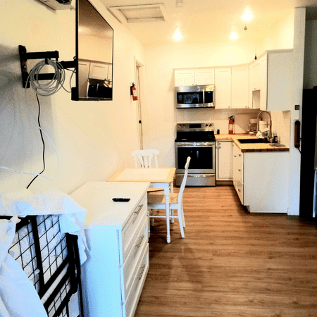 A kitchen with a flat screen tv mounted on the wall