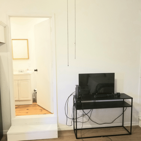 A television is sitting on a desk in a living room
