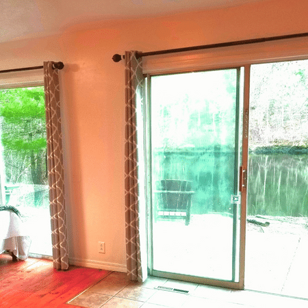 A living room with a sliding glass door leading to a patio.