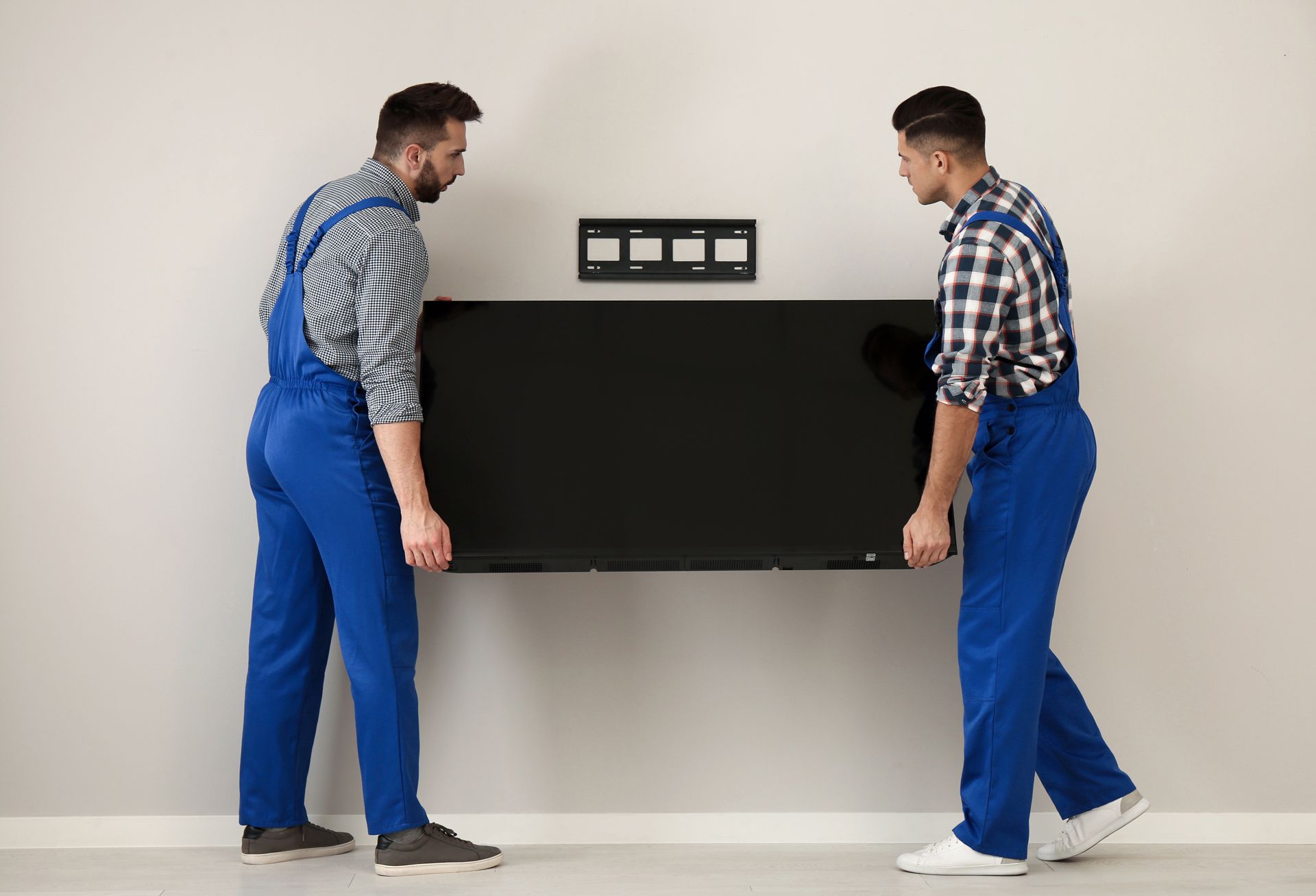 Two Men Carrying Flat Screen TV