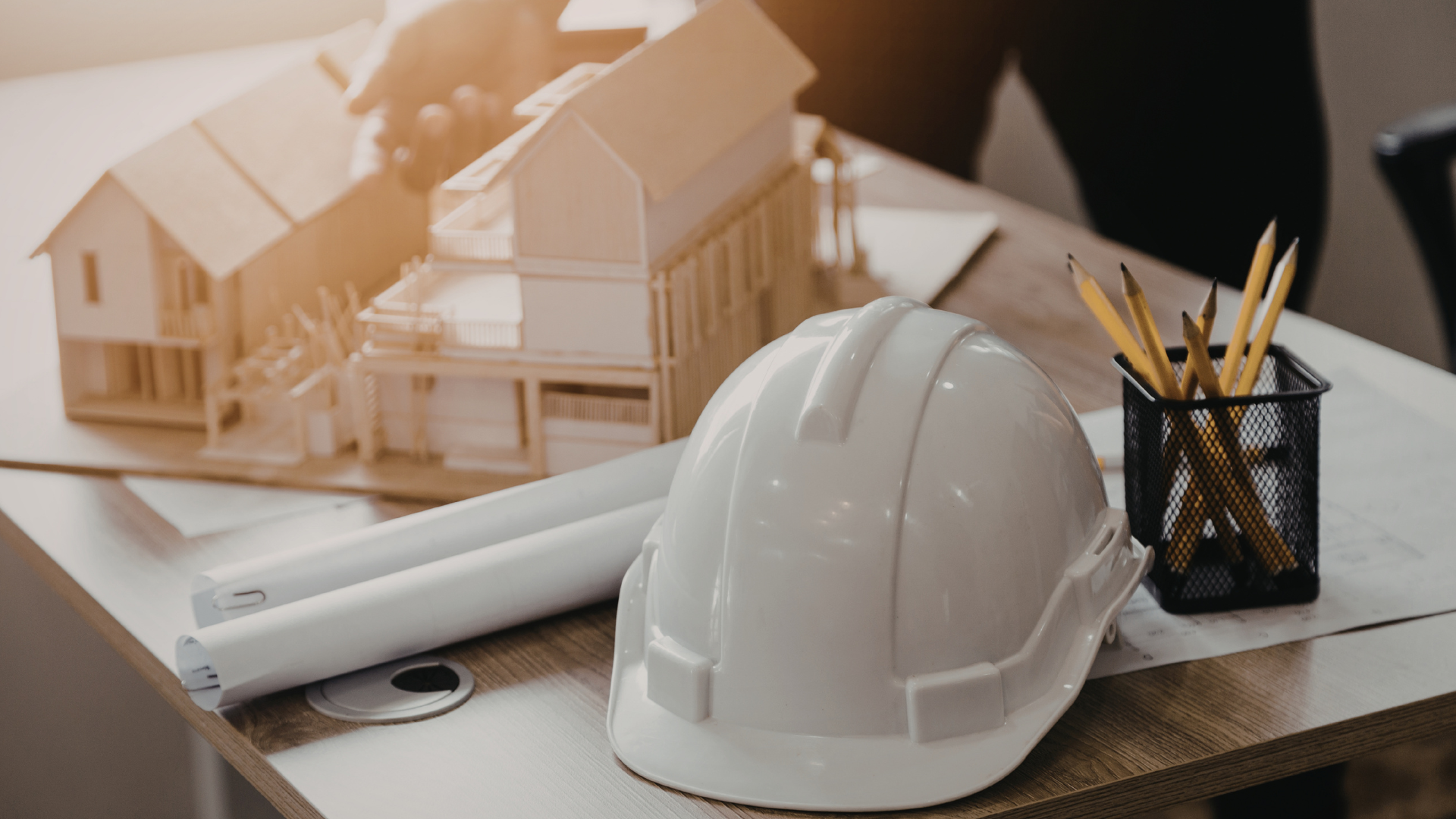 hard hat & construction model home on desk