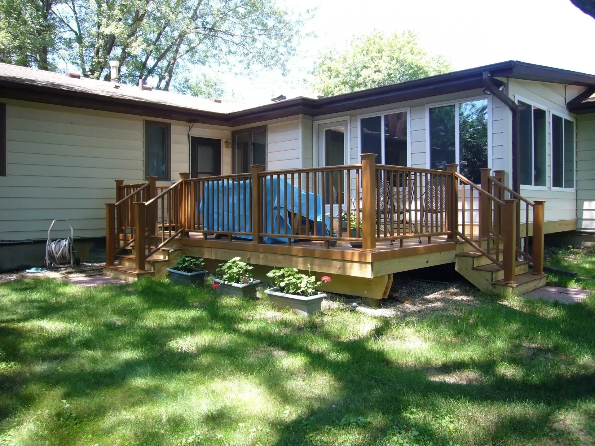 House with Wooden Deck and Stairs — Iowa City, IA — Olson Remodeling & Construction House with Wooden Deck and Stairs — Iowa City, IA — Olson Remodeling & Construction