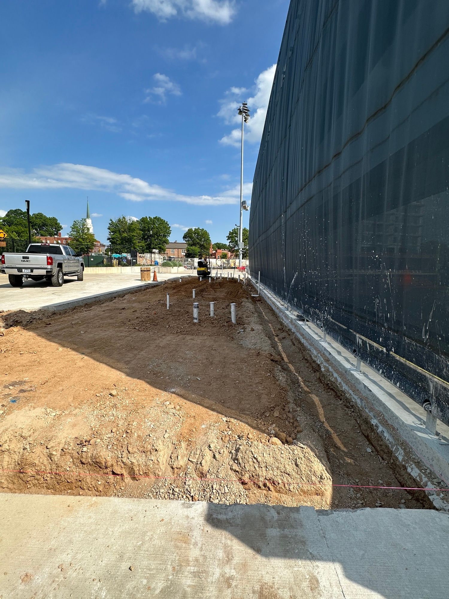 A truck is parked in front of a building under construction.
