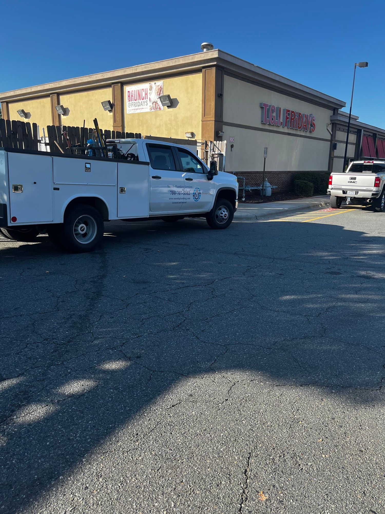A white truck is parked in front of a building.