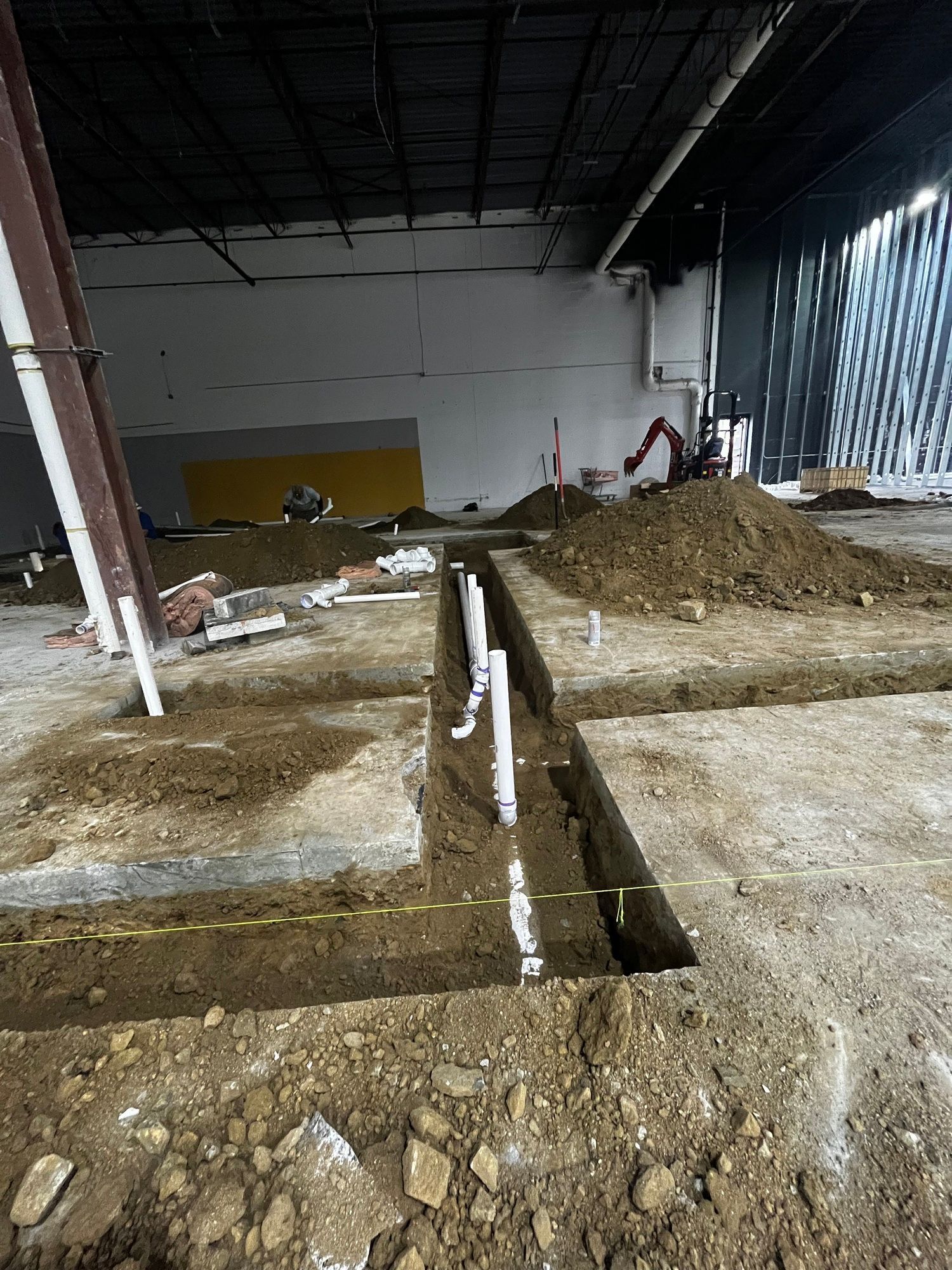 A large building under construction with a lot of dirt on the ground.