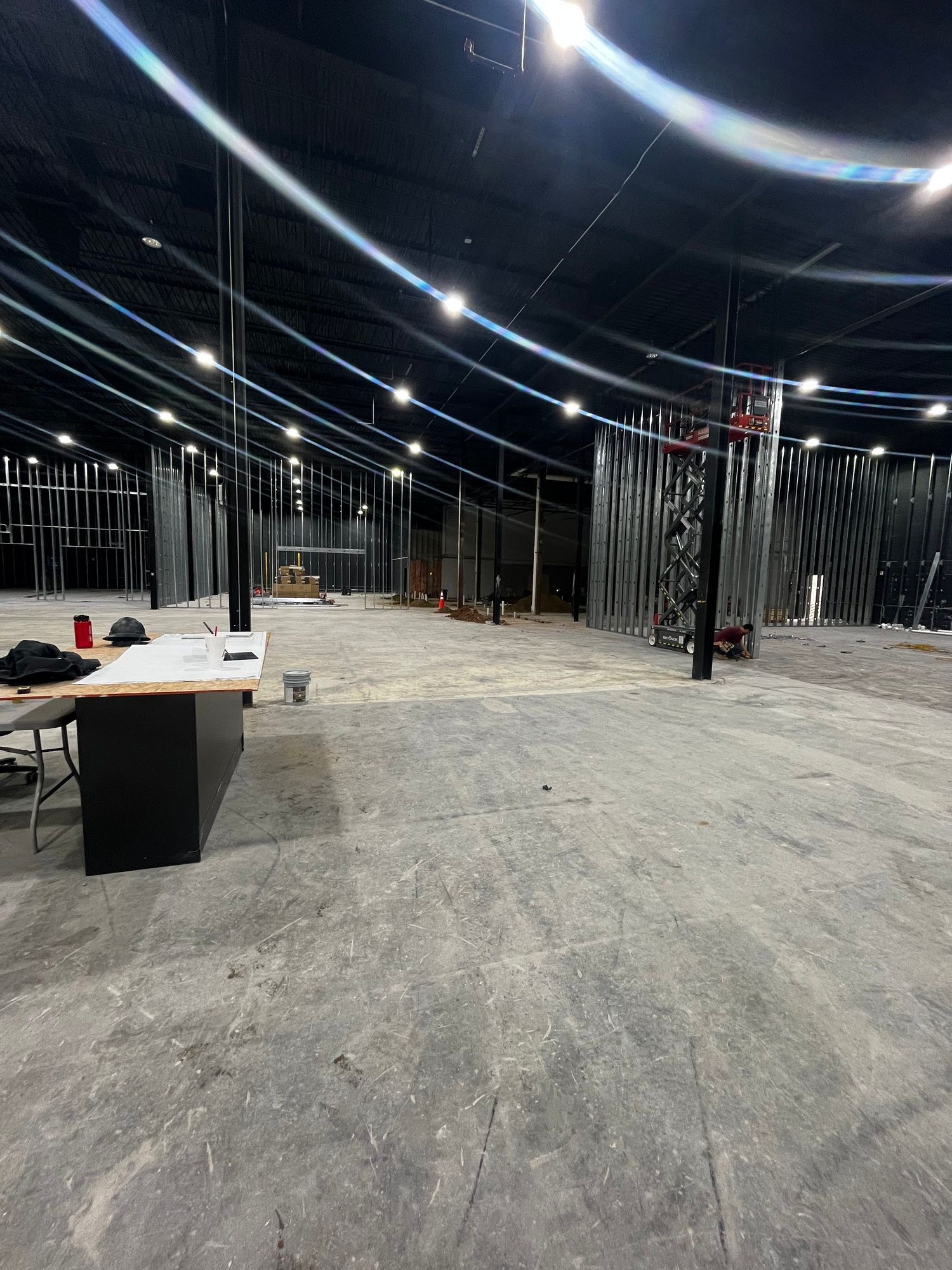 A large empty room with a table and chairs in it.