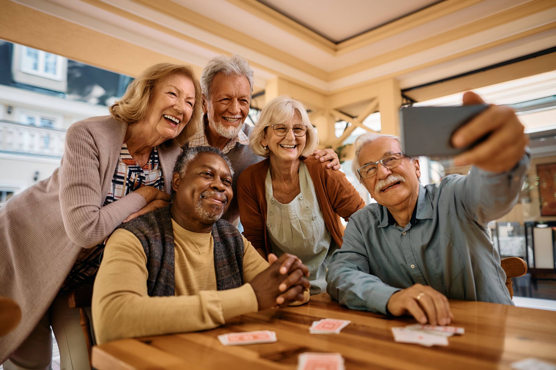 Five like-minded people living in a 55+ community and enjoying a game of cards at Silverfern Senior Living near Cincinnati, Ohio (OH)