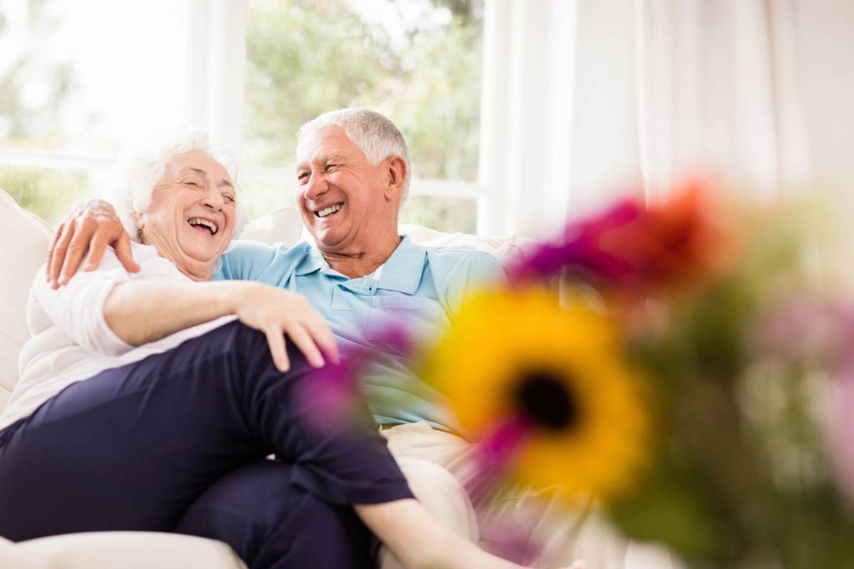 A 55+ couple hugging and laughing together near Cincinnati, Ohio
