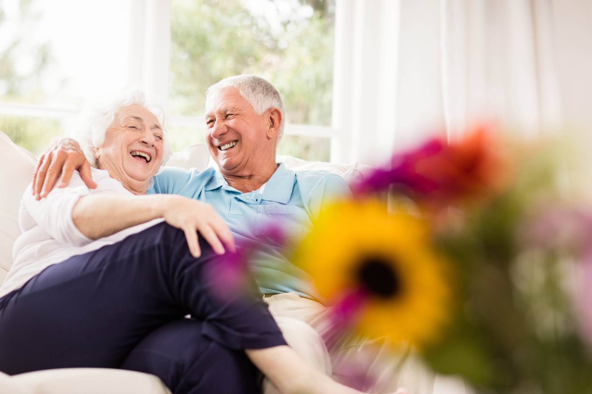 A 55+ couple hugging and laughing together near Cincinnati, Ohio