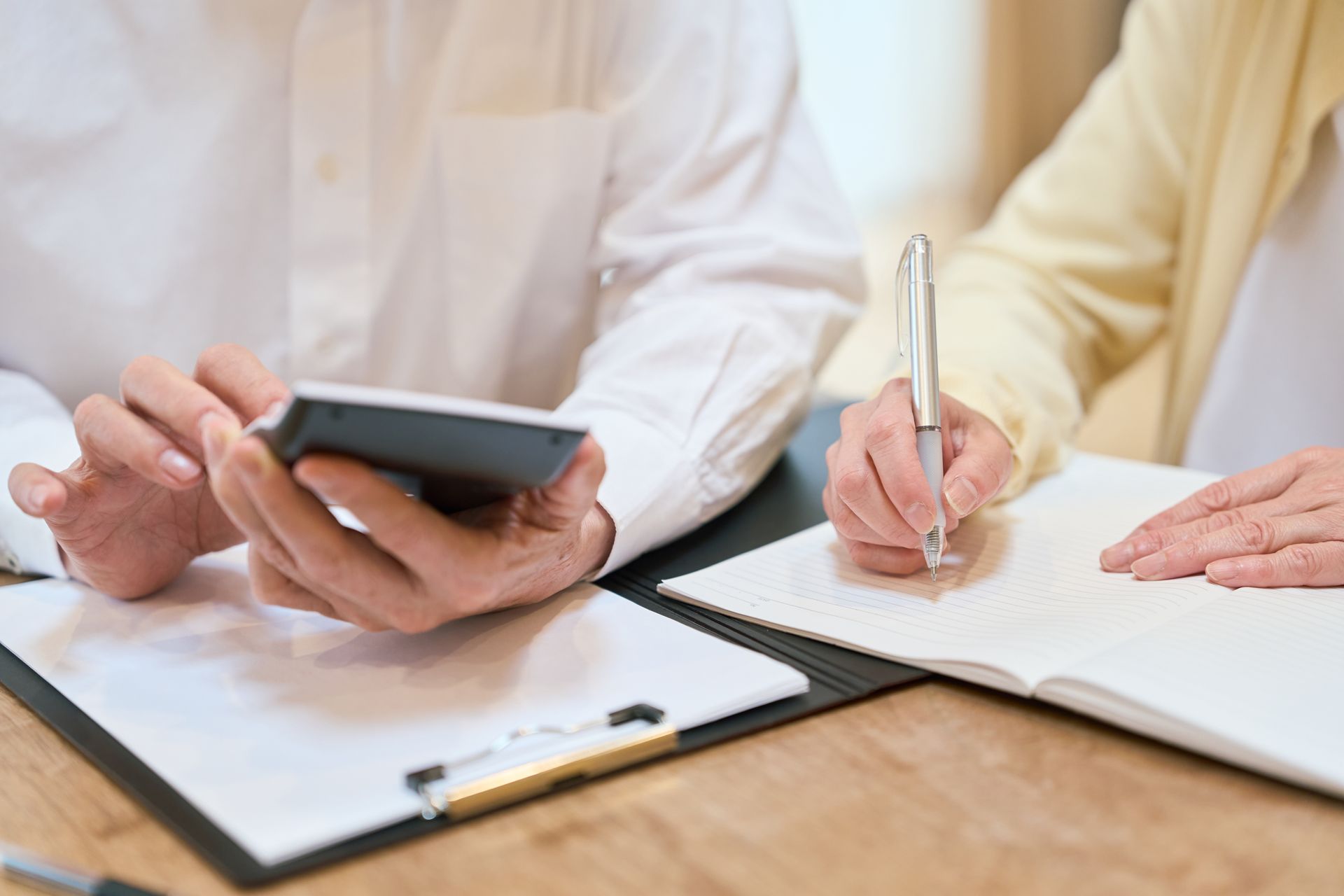 Two people figuring out the costs of senior living compared to their income