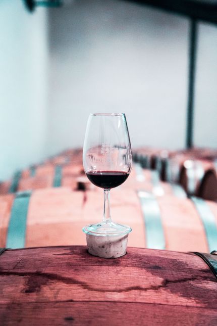 Wine glass on a table with a pink tablecloth in a softly blurred restaurant setting