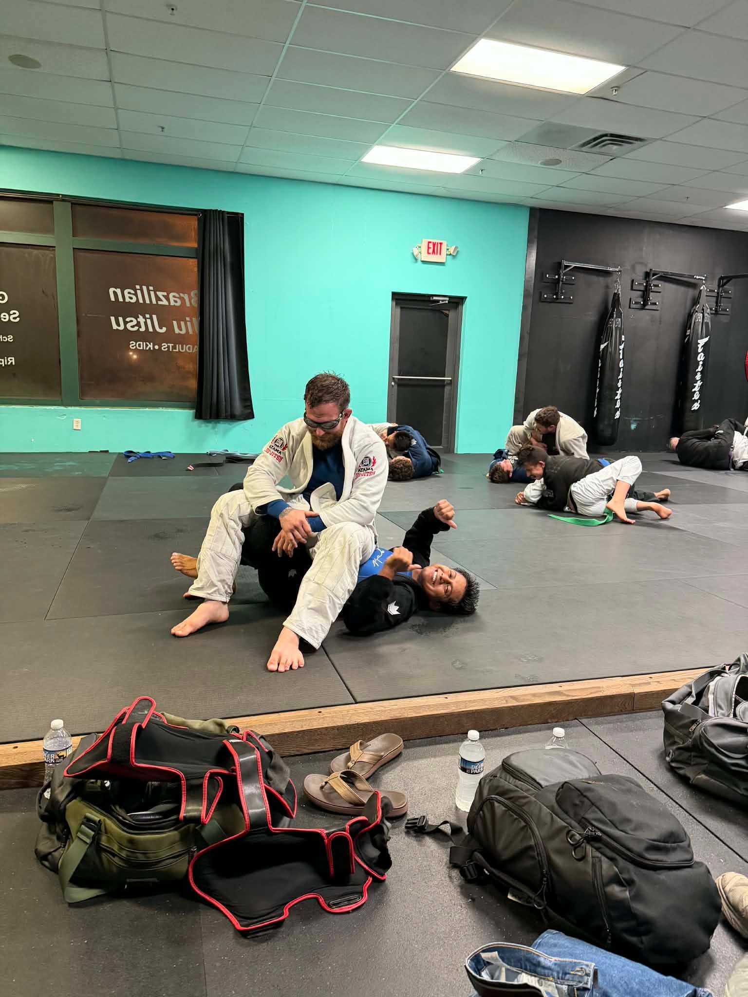 Adult students drilling Brazilian Jiu-Jitsu techniques at Rip Tide Brazilian Jiu Jitsu in Lewes, DE.