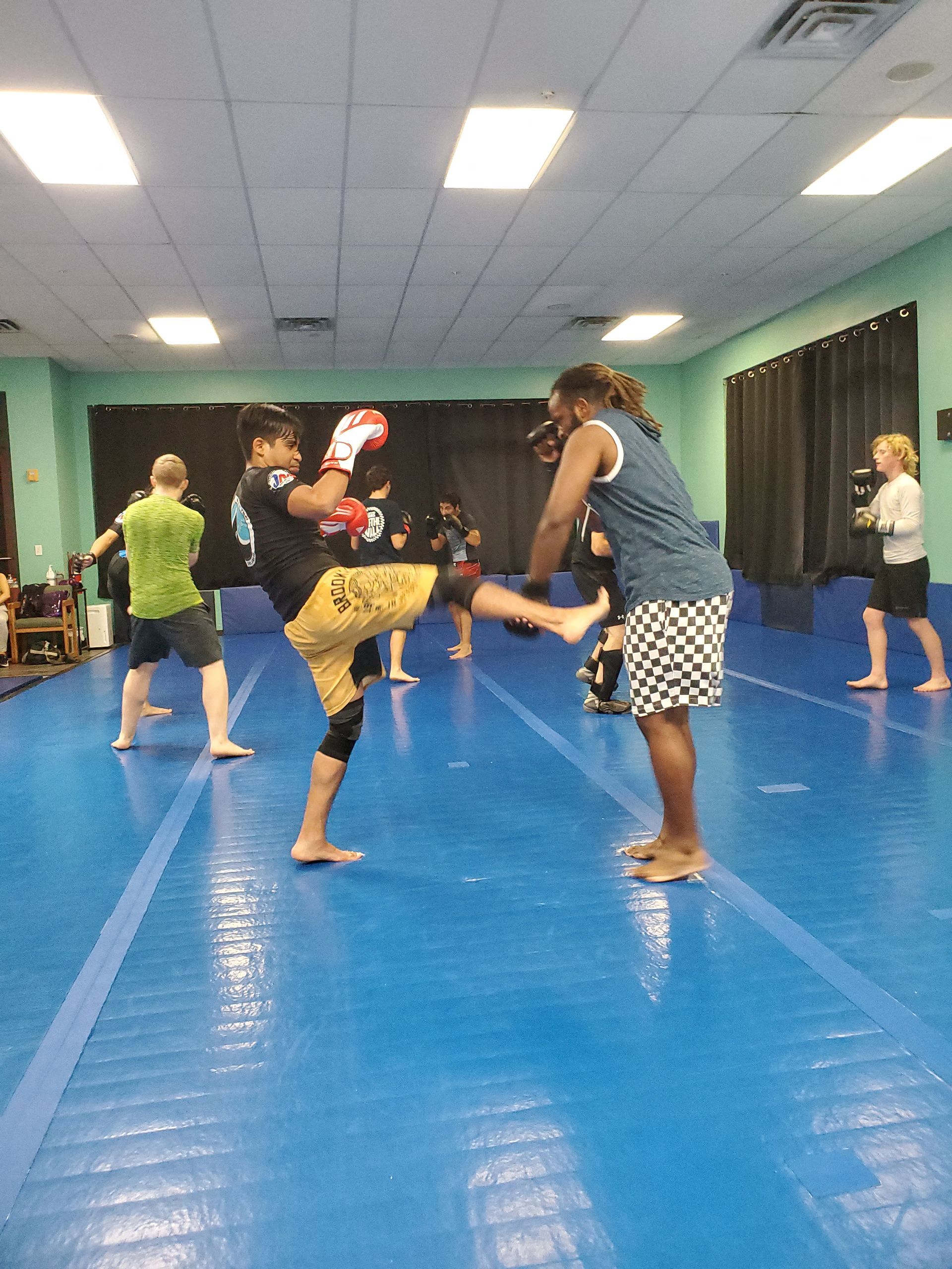 Adults practicing controlled grappling at Rip Tide Brazilian Jiu Jitsu in Lewes, DE.