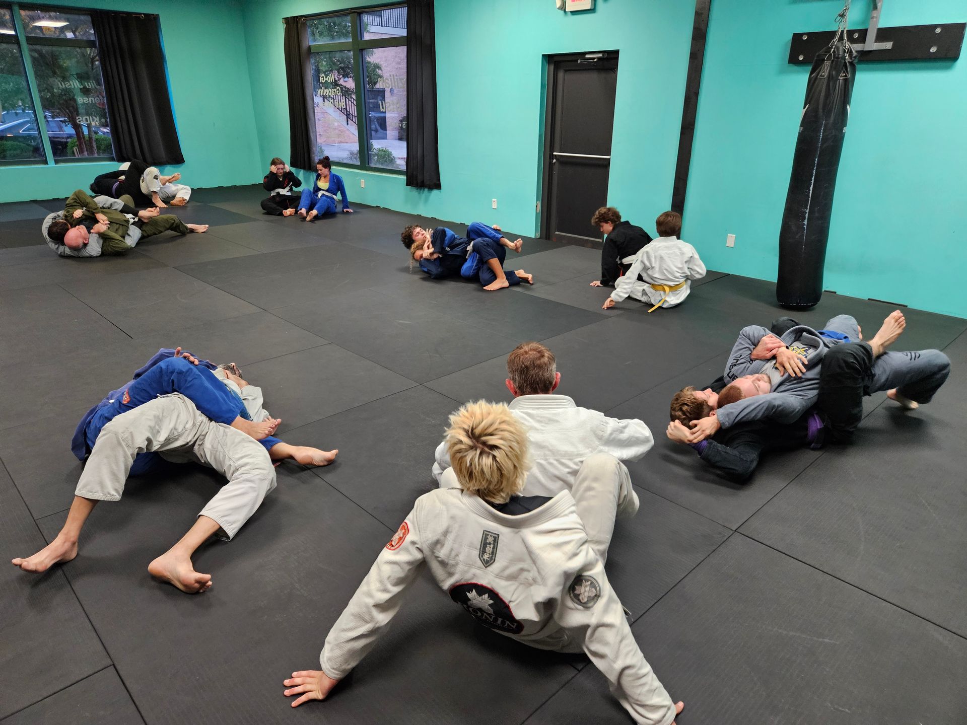 Adults drilling Brazilian Jiu-Jitsu basics at Rip Tide Brazilian Jiu Jitsu in Lewes, DE for fitness.