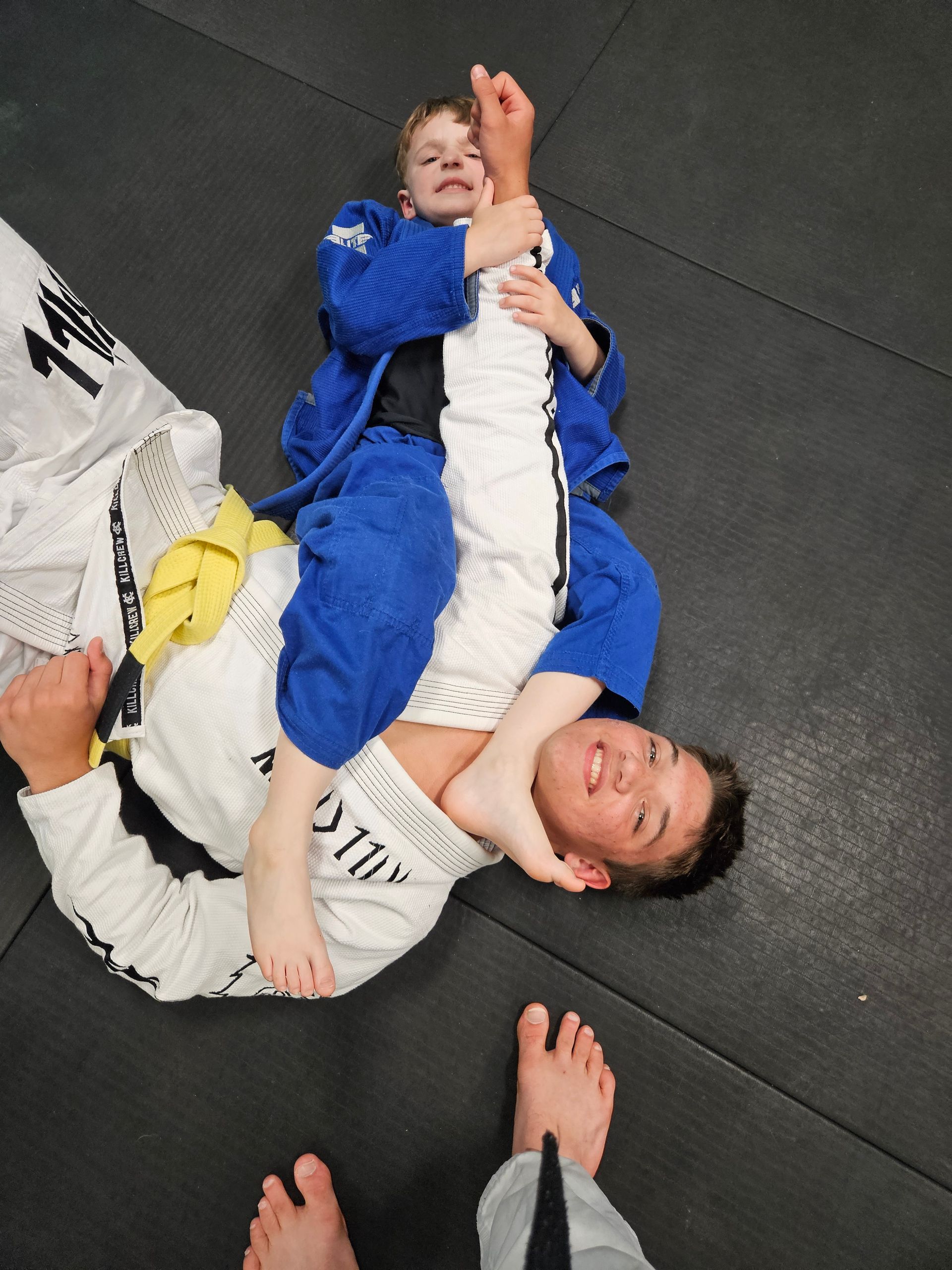 Kids practice grappling drills on mats at Rip Tide Brazilian Jiu Jitsu in Lewes, DE.