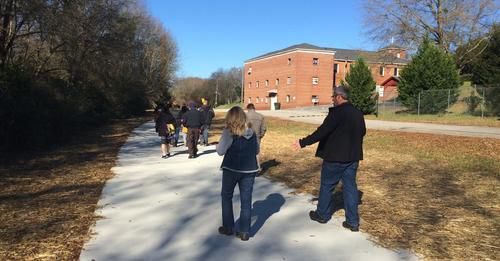 A group of people are walking down a path.
