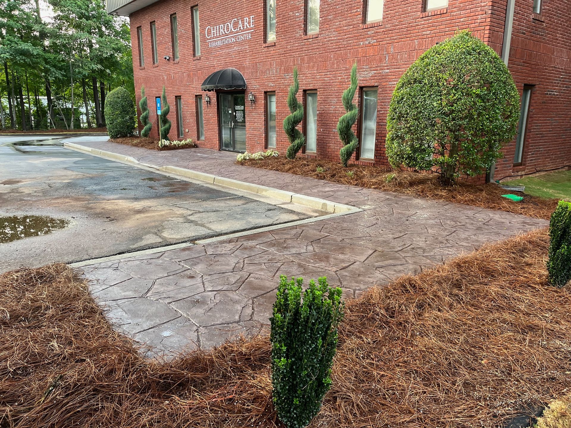 A brick building with a parking lot in front of it.