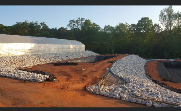 A large white tent is sitting on top of a pile of rocks.