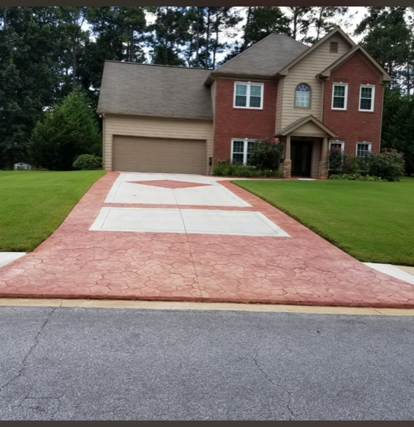 A brick house with a driveway leading to it